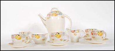 A early 20th Century Art Deco Clarice Cliff style part coffee service by Tams ware in the Bouquet