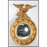 A 19th century gilt wood and gesso convex porthole mirror applied with eagle atop. The circular