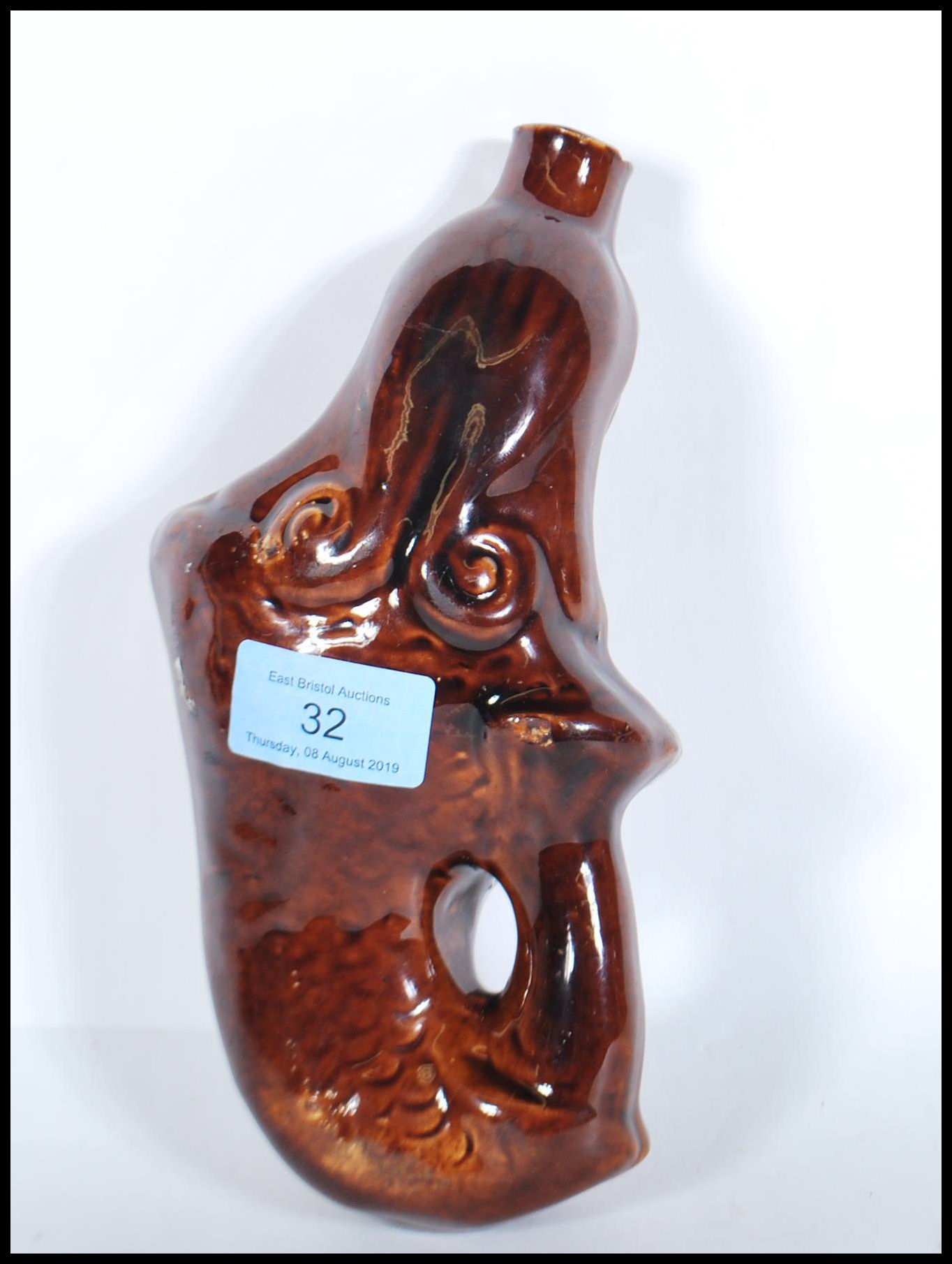 A mid 19th century treacle glaze gin flask in the form of a mermaid. Circa 1840, with waisted top - Image 2 of 6