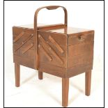 A Scandinavian mid 20th Century teak wood retro cantilever metamorphic sewing box with bent wood