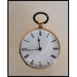 An 18ct gold cased open face pocket fob watch having a white enamelled face with roman numerals to