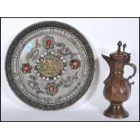An early 20th Century copper hand worked Persian style coffee pot together with a large wall charger