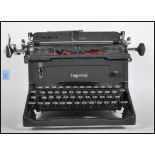 An early 20th century vintage industrial manual typewriter by Imperial, having an A3 roller and