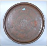 A very heavy and unusual believed 19th century copper charger decorated with central leaf and