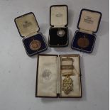 A group of 20th Century medals one being Masonic silver medal on a white ribbon, another silver with