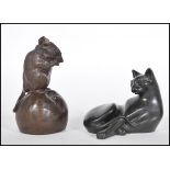 A 20th Century bronze effect figure of a mouse sitting atop of an apple nibbling on a piece of it.