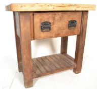 A large antique style heavy country pine scullery butchers block style kitchen table. Raised on