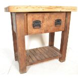 A large antique style heavy country pine scullery butchers block style kitchen table. Raised on