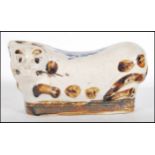 A 19th Century Chinese porcelain headrest pillow in the form of a cat brown decoration with blue and