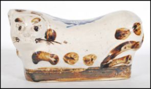 A 19th Century Chinese porcelain headrest pillow in the form of a cat brown decoration with blue and