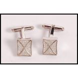 A pair of stamped 925 silver cufflinks having square heads set with CZ's. Weight 8.5g.