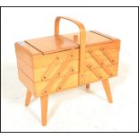 A retro 20th Century beech cantilever metamorphic work / sewing box, carry handle over sectional