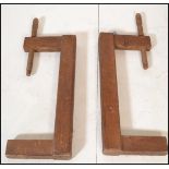 A pair of 19th century German wooden clamps with large thread handles together with a pair of 20th