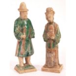 A pair of antique Chinese Ming dynasty (1368 – 1644) glazed pottery figures / tomb attendants in the