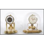 A good quality Kern Anniversary clock having brass movement and ceramic dial  set within a glass