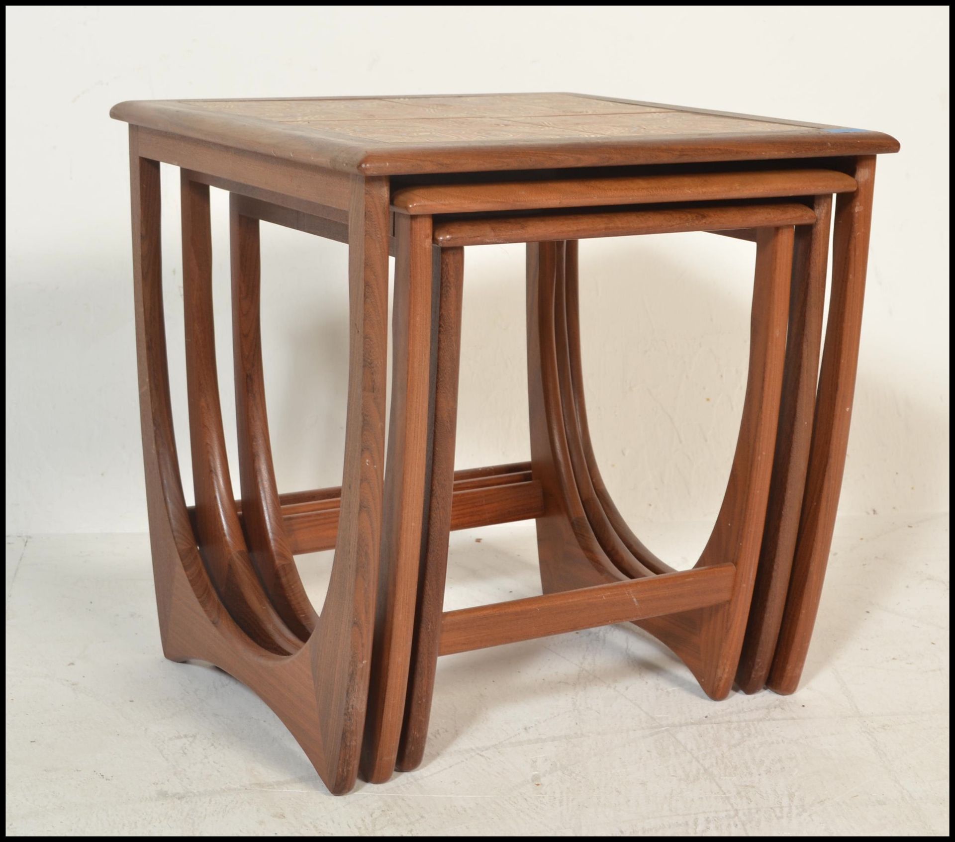 A 1970's G-Plan ' Astro ' teak wood nest of tables. The tables of graduating form with each being