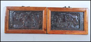 A pair of 19th century Chinese lacquer panels featuring relief scenes of villagers within modern