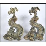 A pair of late 19th early 20th Century cast brass door stops modelled as Maltese Dolphins.