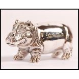 A stamped sterling silver figurine of a hippopotamus. Weight 18.6g. Measures 2cm tall.