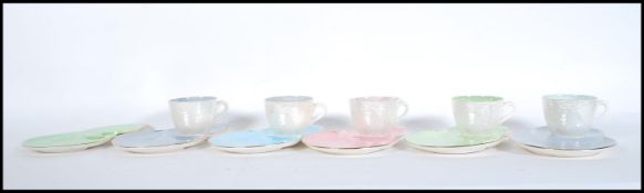 A set of 20th Century Maling porcelain harlequin lustre tennis sets / tea cups and saucers, finished