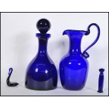 A collection of Bristol Blue studio glass to include a decanter with stopper, ewer, cat and a