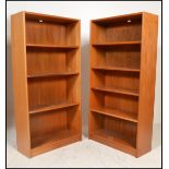 A pair of tall retro teak wood open window bookcases fitted with a series of adjustable shelves