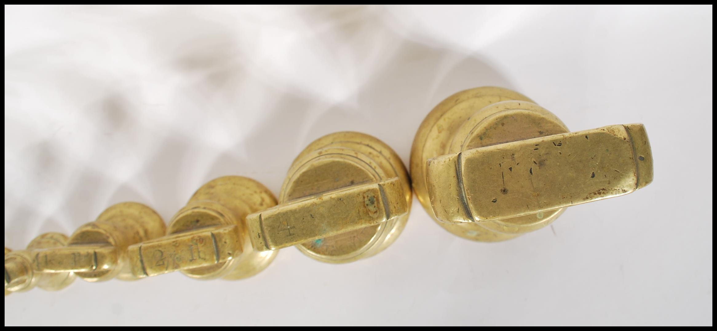 A selection of 20th century graduating brass bell weights having carrying handles atop, with the - Image 5 of 7