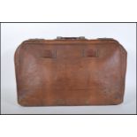 A vintage mid 20th Century tan brown leather Gladstone / Doctors bag, carry handle atop with twin