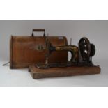 An early 20th century dome top oak cased Singer sewing machine. The case complete with key and