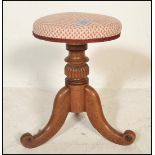 A Victorian 19th century mahogany revolving piano stool. Mid 19th century having an upholstered