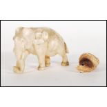 A good quality antique carved ivory figure of a elephant in a walking position. Together with a