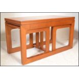 A retro 20th Century Danish inspired teak wood coffee table \ nest, flip over extending table top