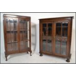 A 1930's Queen Anne oak china display cabinet raised on cabriole legs with claw and ball feet. Above