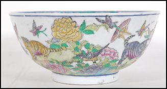 A 20th Century Chinese centre bowl transfer printed with garden scenes with cats and kittens, the