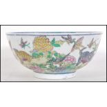 A 20th Century Chinese centre bowl transfer printed with garden scenes with cats and kittens, the