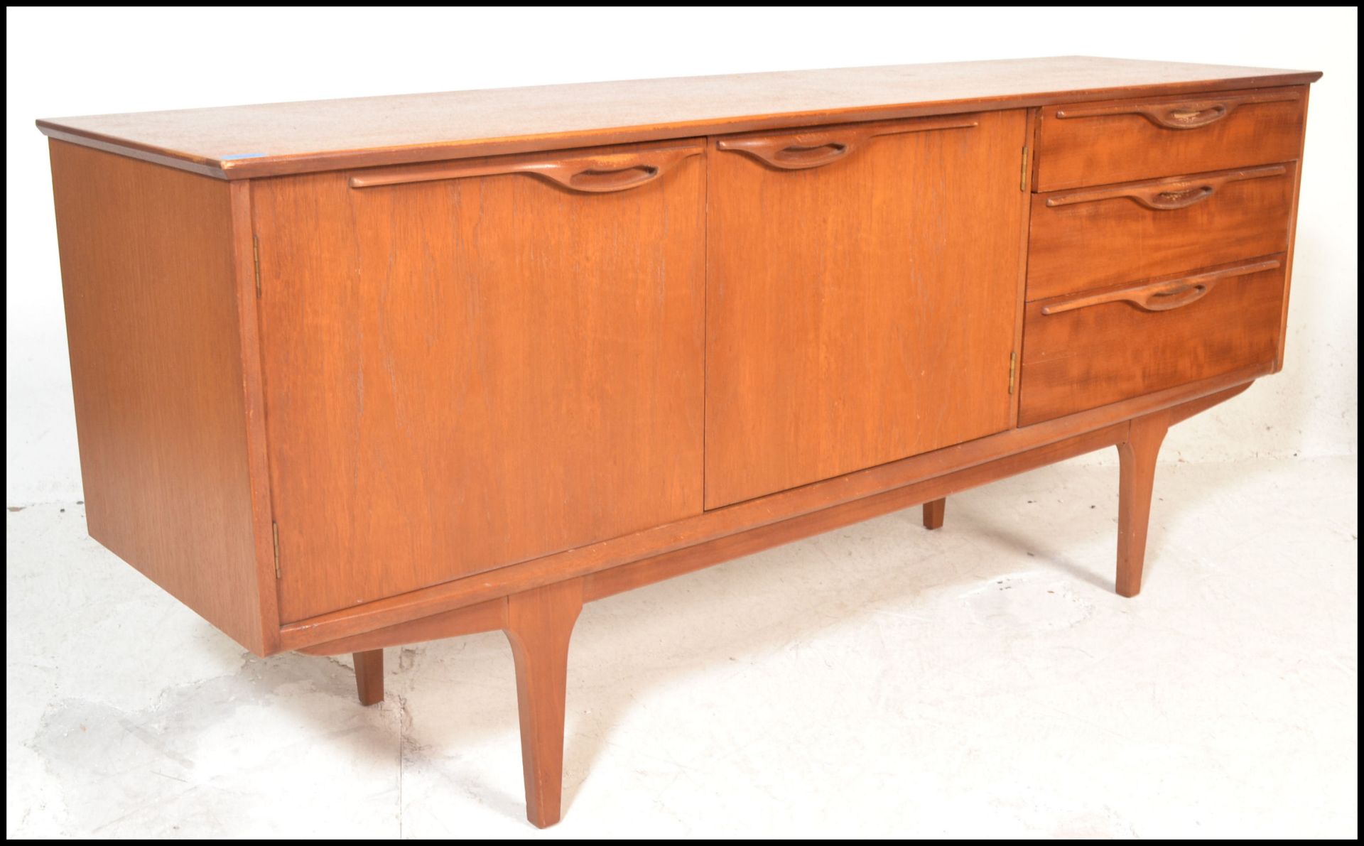 A mid 20th Century retro teak wood sideboard / credenza, having twin cupboard doors to left