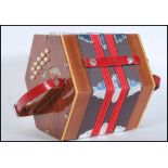 The Gremlin- A 20th century twenty one button concertina / squeeze music box, having pierced