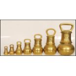 A set of seven 19th / 20th Century graduating brass bell weights, the largest weighing 14LB's and