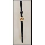 A marked 18k gold ladies wrist watch by Tudor having gilt baton numerals with faceted hands, set