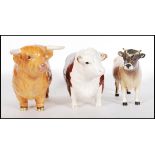 A Beswick ceramic figure modelled as a Highland Bull together with a Beswick Hereford Bull and a