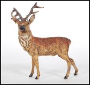 An early 20th Century Austrian cast spelter cold painted figurine in the form of a stag, still