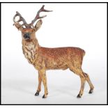 An early 20th Century Austrian cast spelter cold painted figurine in the form of a stag, still
