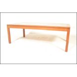 A  mid 20th century large Danish inspired teak wood and tile top long john coffee table. Raised on