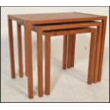 A 20th century retro vintage teak wood nest of tables of simple form with exposed finger joints to