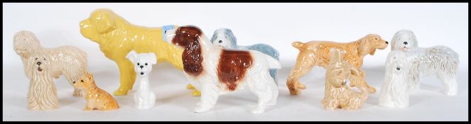 A collection of vintage 20th Century ceramic dog figurines by Sylvac to include a large St Bernard