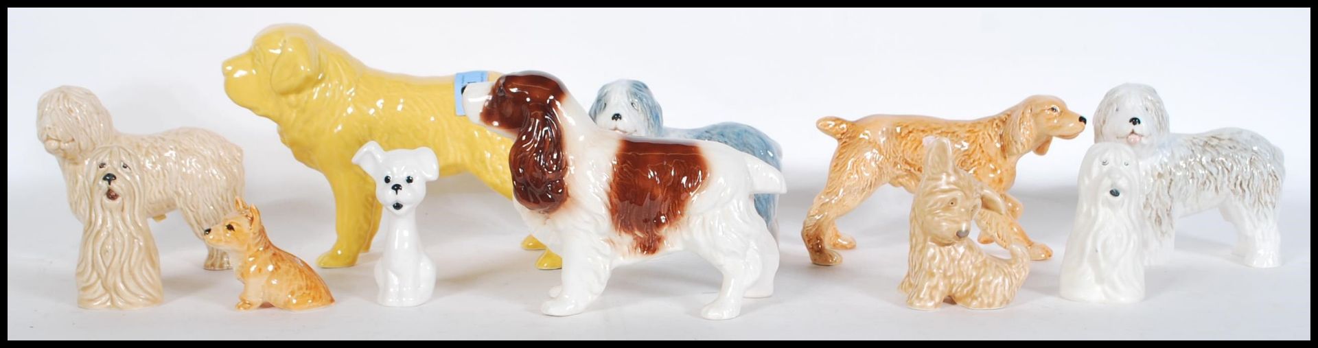 A collection of vintage 20th Century ceramic dog figurines by Sylvac to include a large St Bernard