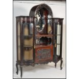 A 19th century Victorian large bow front and dome top vitrine display cabinet. Raised on cabriole