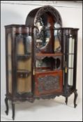 A 19th century Victorian large bow front and dome top vitrine display cabinet. Raised on cabriole