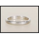 A hallmarked platinum band ring having worn decoration to band. Hallmarked Birmingham, weight 4.