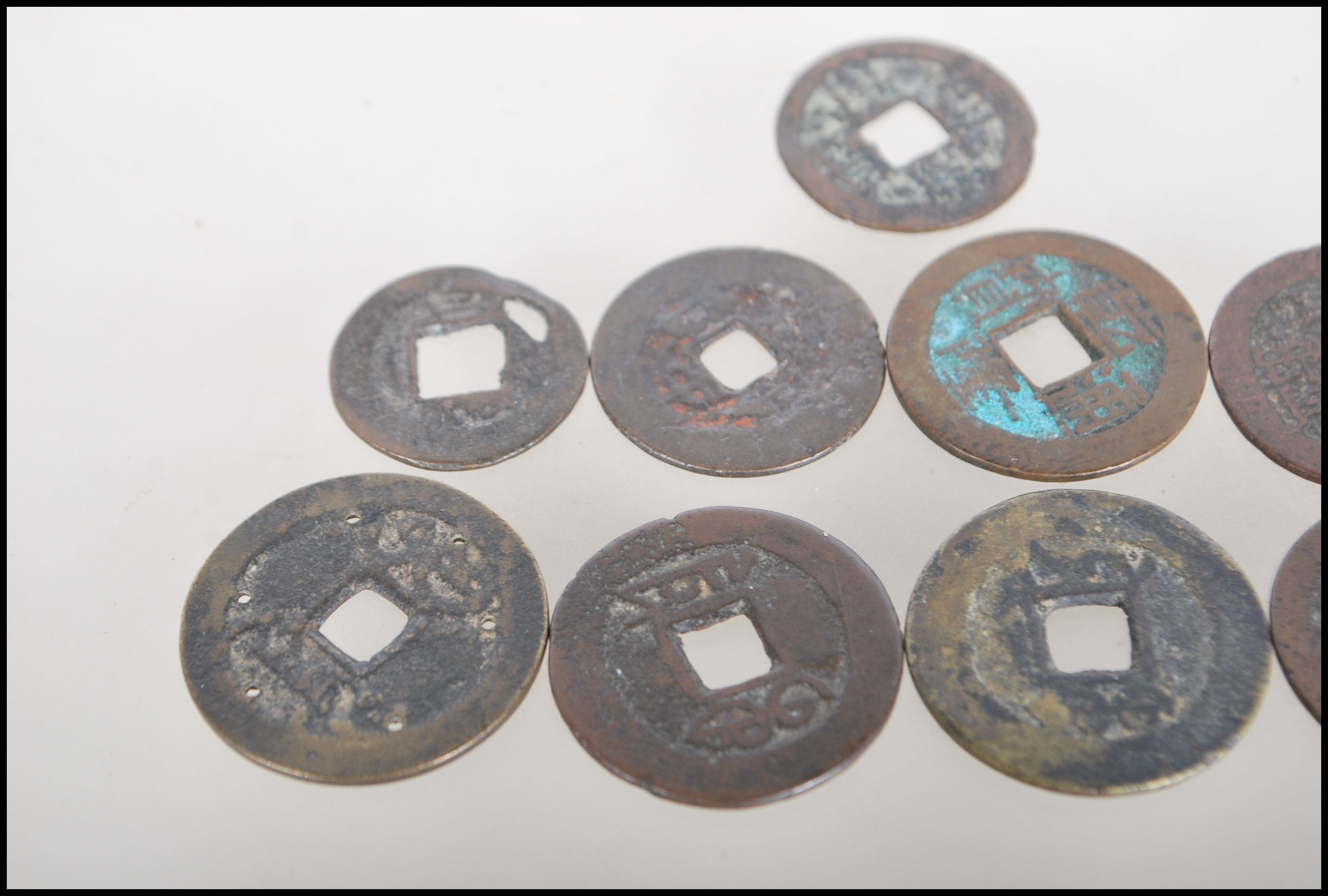 A group of nine Chinese tang dynasty coins having square pierced centres. Nine in total. - Image 6 of 7